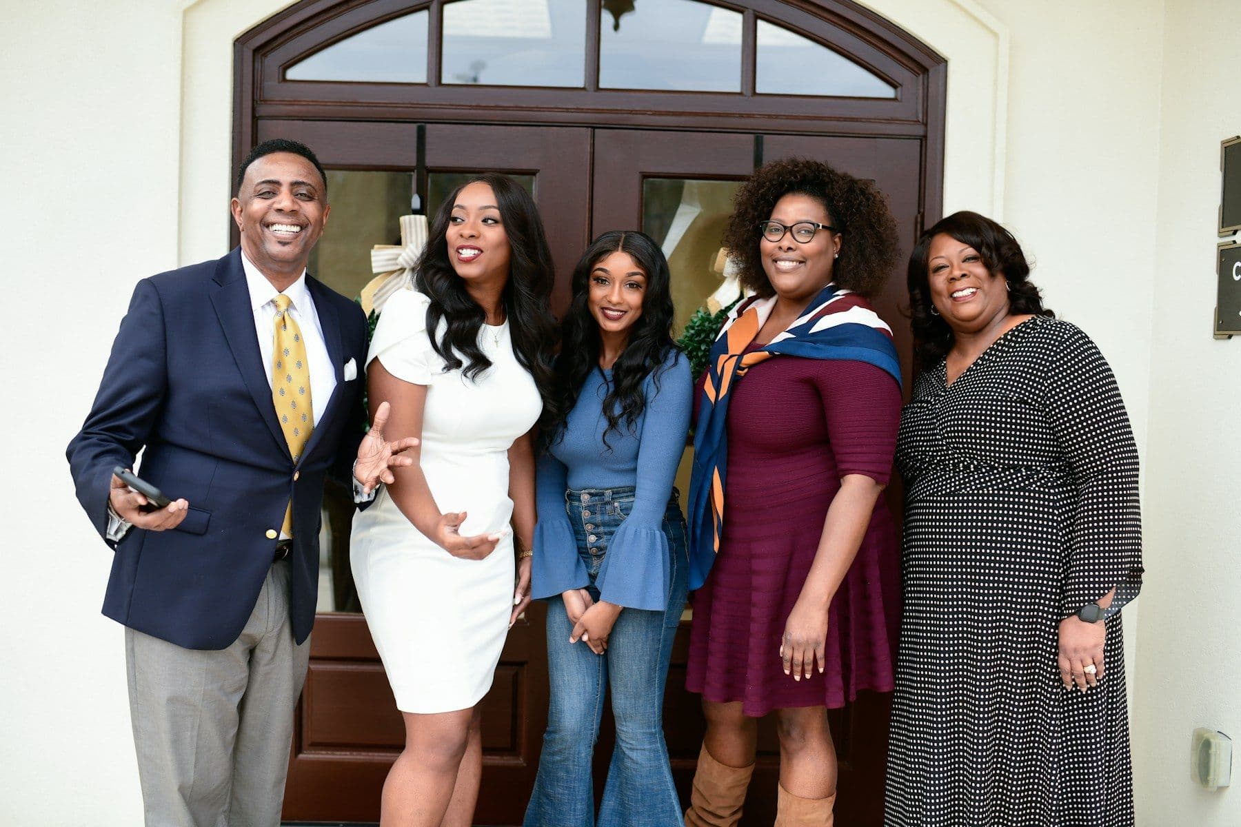 Members of a church family gathered in front of their sanctuary