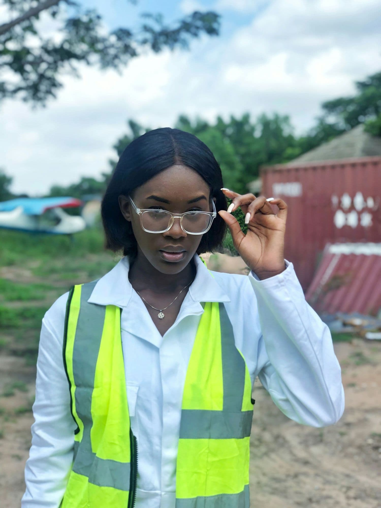 A young woman in a high-visibility safety vest outdoors