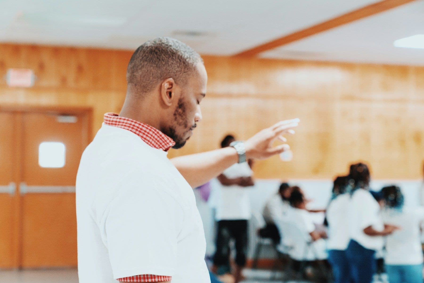 An instructor pointing toward a classroom of participants