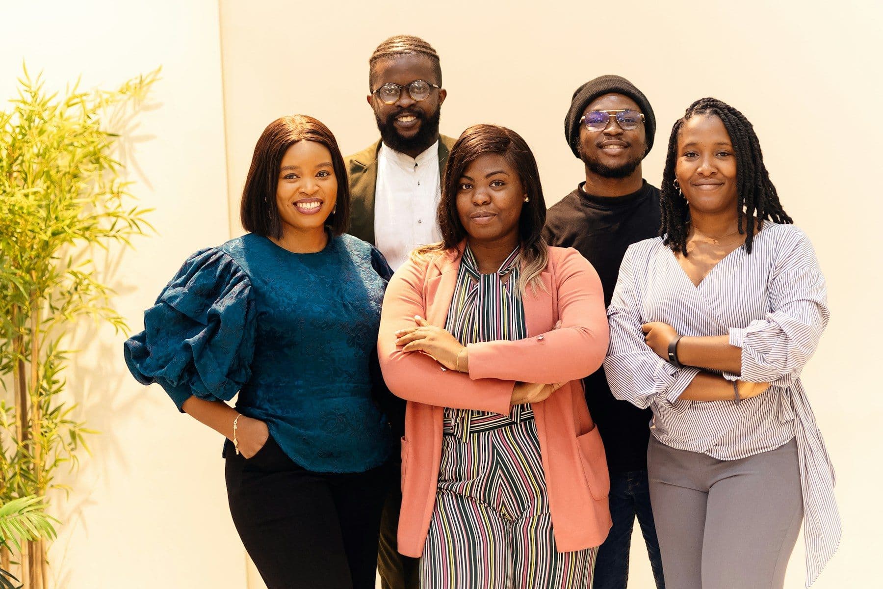 A group of smiling Black professionals standing together